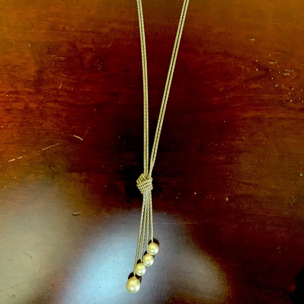 Set of silver tone, knotted pearl necklace with matching earrings